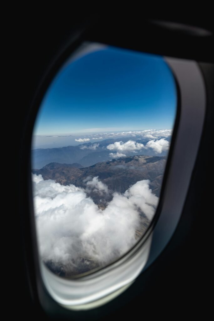 pexels-photo-1660194-1660194 A breathtaking aerial view of clouds and mountains through an airplane window.